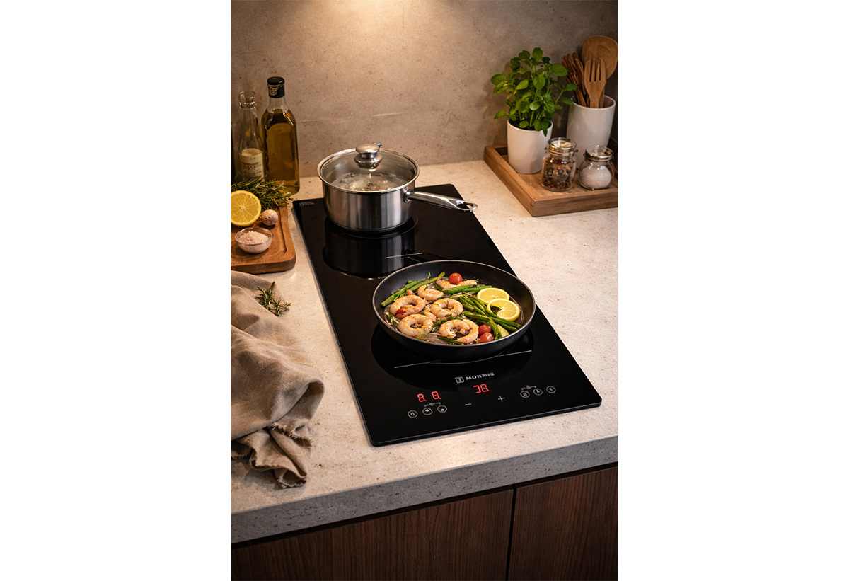 Απεικονίζεται η εστία σε πάγκο κουζίνας με μαγειρικά σκεύη πάνω.